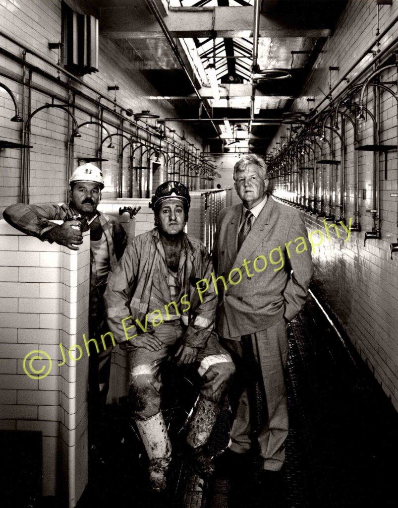 Miners in Tower Colliery pithead bathhouse (left to right): Dennis Davies (lampman), Brian Griffiths (carpenter) and Chairman, Tyron O'Sullivan pose in the Tower Colliery pithead bathhouse, Wales, UK.